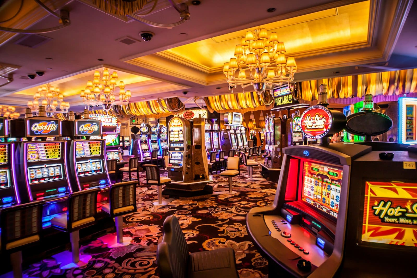 Crypto News & Market Analysis | Auxilium Global 5 Rows of illuminated slot machines representing sweepstakes casino slot games
